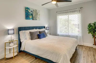 a bedroom with a large bed and a window at 4 Mi to Dtwn Oceanside and Beach Home with Yard! in Oceanside