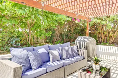 a blue couch with pillows on a patio at 4 Mi to Dtwn Oceanside and Beach Home with Yard! in Oceanside