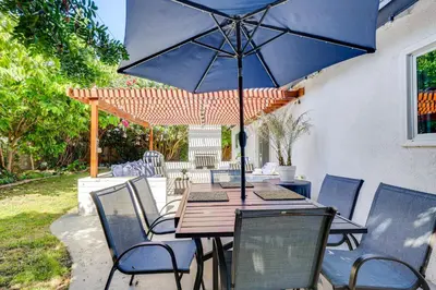 a table and chairs with an umbrella on a patio at 4 Mi to Dtwn Oceanside and Beach Home with Yard! in Oceanside