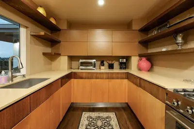 a kitchen with wooden cabinets and a sink at Bridgeview Retreat Near Balboa Park in San Diego
