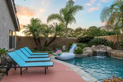 a pool with a inflatableitatingitatingitatingitatingitatingitatingitatingitatingitatingitating at Entire Private Home with 4 Bedrooms, Pool, Hot Tub, King Bed, Garage, Available Now in El Cajon