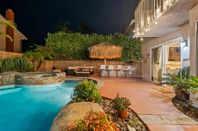 a backyard with a swimming pool and a patio at Entire Private Home with 4 Bedrooms, Pool, Hot Tub, King Bed, Garage, Available Now in El Cajon