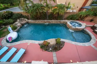 an overhead view of a pool with a water slide at Entire Private Home with 4 Bedrooms, Pool, Hot Tub, King Bed, Garage, Available Now in El Cajon