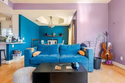 a blue couch in a living room with a table at Oasis Hillcrest in San Diego