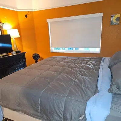 a bedroom with a large bed and a window at Oasis Hillcrest in San Diego