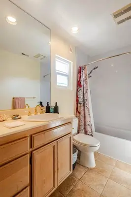 a bathroom with a sink and a toilet and a mirror at Oasis Hillcrest in San Diego