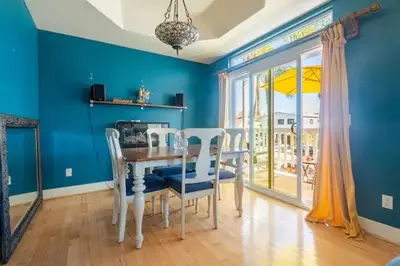 a dining room with blue walls and a table and chairs at Oasis Hillcrest in San Diego