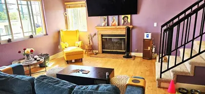 a living room with a couch and a fireplace at Oasis Hillcrest in San Diego