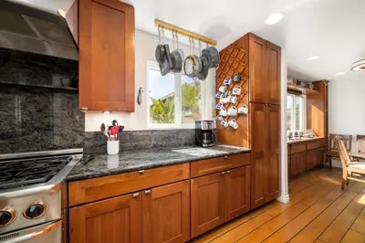 a kitchen with wooden cabinets and a counter top at Hot Tub Ocean Views 3 Bedroom Private Home in Carlsbad