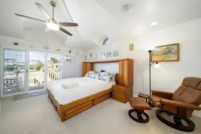 a bedroom with a bed and a chair at Hot Tub Ocean Views 3 Bedroom Private Home in Carlsbad