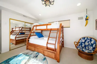 a bedroom with two bunk beds and a mirror at Hot Tub Ocean Views 3 Bedroom Private Home in Carlsbad