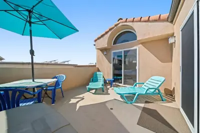 a patio with chairs and a table and an umbrella at Hot Tub Ocean Views 3 Bedroom Private Home in Carlsbad