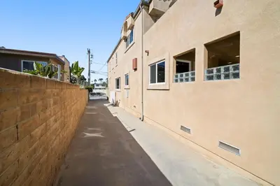 an empty alleyway between two buildings with windows at Hot Tub Ocean Views 3 Bedroom Private Home in Carlsbad