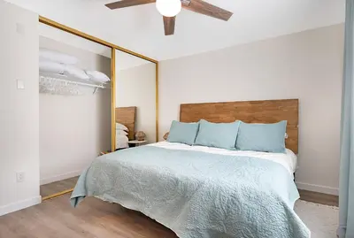 a bedroom with a bed with a large mirror at Sunrise & Sunset by the Sea 812-1 in Oceanside