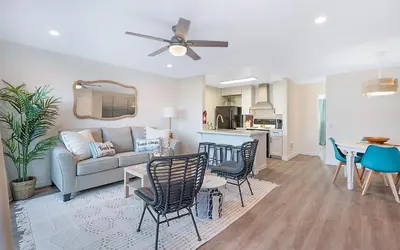 a living room with a couch and a table and chairs at Sunrise & Sunset by the Sea 812-1 in Oceanside