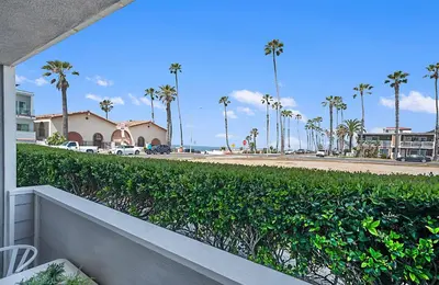 a view of the beach from a balcony of a house at Sunrise & Sunset by the Sea 812-1 in Oceanside