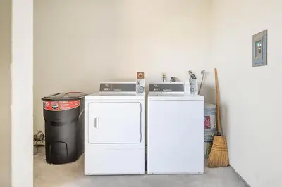 a white refrigerator and a trash can in a room at Sunrise & Sunset by the Sea 812-1 in Oceanside