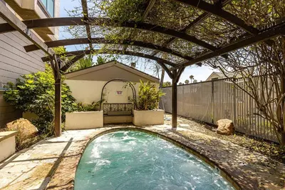 a swimming pool in a backyard with a pergola at North Coast Village Penthouse A306 in Oceanside