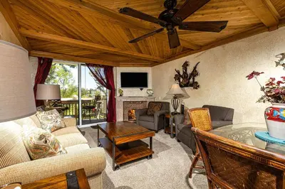 a living room filled with furniture and a ceiling fan at North Coast Village Penthouse A306 in Oceanside