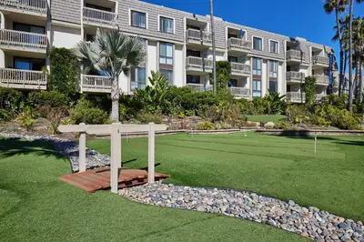 a large apartment building with a tennis court in front of it at North Coast Village B212 in Oceanside