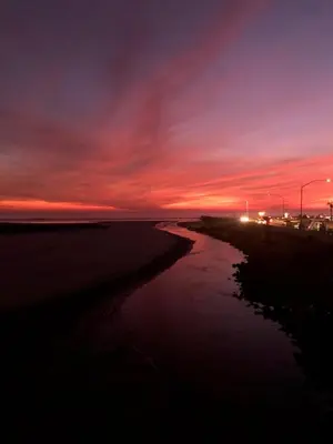 a sunset over a beach with a body of water at North Coast Village Cottage G20 in Oceanside