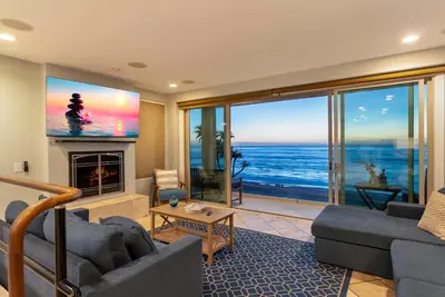 a living room with a view of the ocean at Oceanfront at Windansea Luxe 3-Story Home with Views, AC, Garage in San Diego