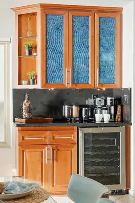 a kitchen with wooden cabinets and a stove top oven at Oceanfront at Windansea Luxe 3-Story Home with Views, AC, Garage in San Diego