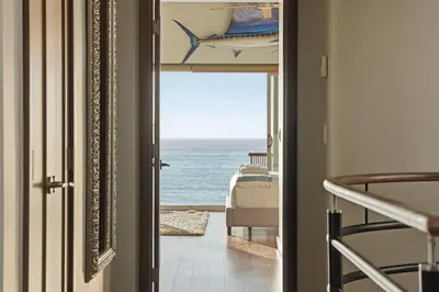 a door leading to a room with a view of the ocean at Oceanfront at Windansea Luxe 3-Story Home with Views, AC, Garage in San Diego