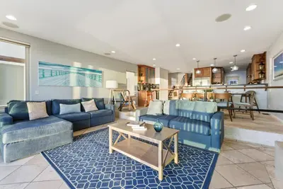a living room with two blue couches and a table at Oceanfront at Windansea Luxe 3-Story Home with Views, AC, Garage in San Diego