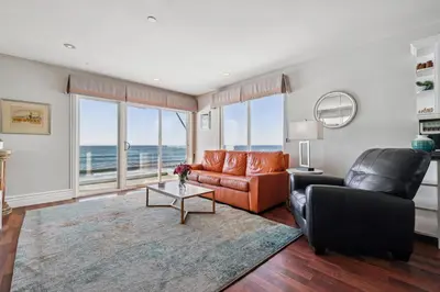 a living room with a couch and a table at Seashore On The Sand in Carlsbad