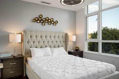 a bedroom with a large bed with a large window at 3BR Downtown Peaceful Corner in San Diego