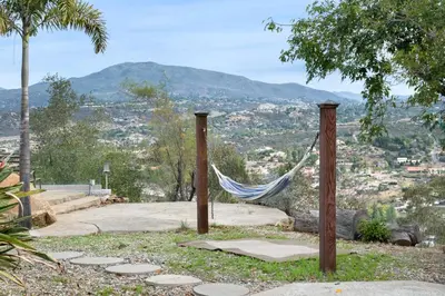 a hammock on a hill with a view of a city at Beso De Cielo or Slow Sip of Solitude in Alpine