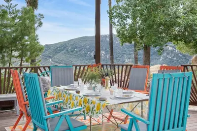 a table and chairs on a deck with a view at Beso De Cielo or Slow Sip of Solitude in Alpine
