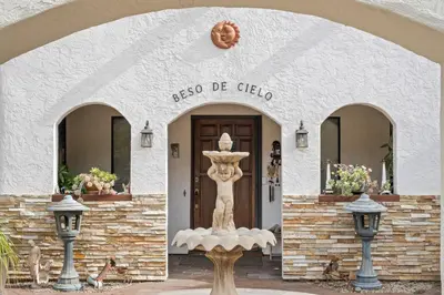 a building with a statue in front of a door at Beso De Cielo or Slow Sip of Solitude in Alpine