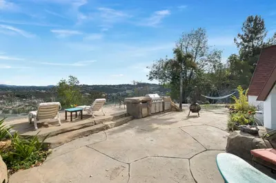 a patio with two chairs and a grill at Beso De Cielo or Slow Sip of Solitude in Alpine