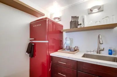 a red refrigerator in a kitchen with a sink at Coastal SD Retreat Studio Pets Close to Ocean in San Diego