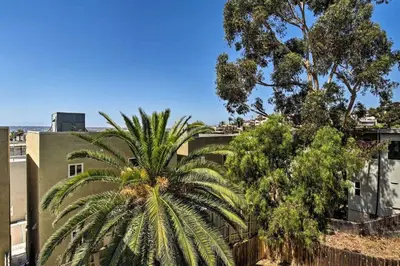 a palm tree in front of a building at Cozy Apt W Patio Bankers Hill SD in San Diego