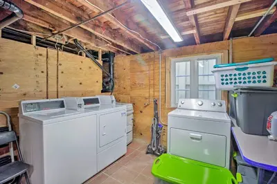 a washer and dryer in a room with wooden walls at Cozy Apt W Patio Bankers Hill SD in San Diego