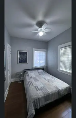 a bedroom with a bed and a ceiling fan at Cozy Apt W Patio Bankers Hill SD in San Diego