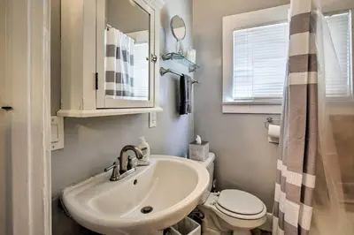 a bathroom with a sink and a toilet and a mirror at Cozy Apt W Patio Bankers Hill SD in San Diego