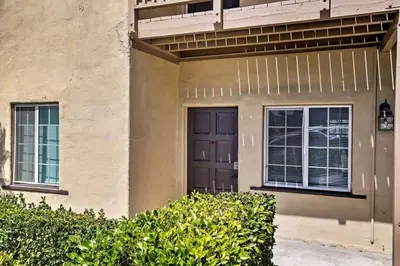 a house with a brown door and two windows at Cozy Apt Near GasLamp in San Diego
