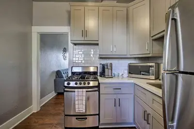 a kitchen with white cabinets and a stove at Cozy Apt Near GasLamp in San Diego