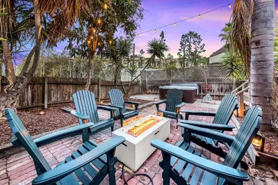 a patio with chairs and a table and a fire pit at Designer Oasis with Hot Tub Firepit BBQ Sleeps 6 in San Diego