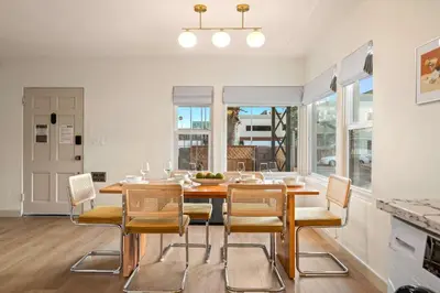 a dining room with a table and chairs at Designer Oasis with Hot Tub Firepit BBQ Sleeps 6 in San Diego