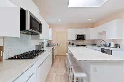 a kitchen with white cabinets and a stove top oven at Spacious Single Level Home In Poway in Poway