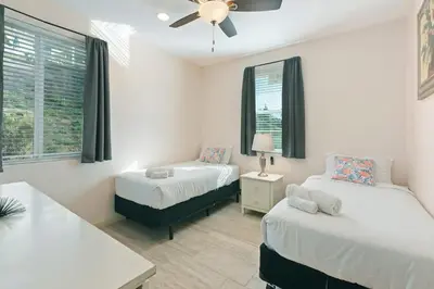 a bedroom with two beds and a ceiling fan at Spacious Single Level Home In Poway in Poway