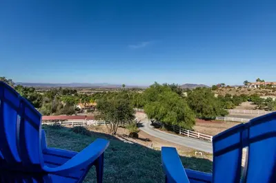 a couple of blue chairs sitting on top of a field at The Zen House Temecula in Temecula