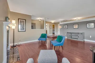 a living room with two blue chairs and a table at The Zen House Temecula in Temecula