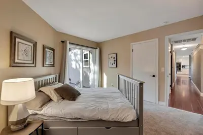 a bedroom with a bed with a lamp and a window at The Zen House Temecula in Temecula