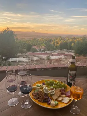 a plate of food on a table with wine glasses at The Zen House Temecula in Temecula